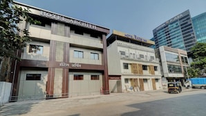A hotel named Hotel Archith with a modern facade, a visible entrance, and a sign in a local language. - Archit By Glitz Hotels (Navi Mumbai)
