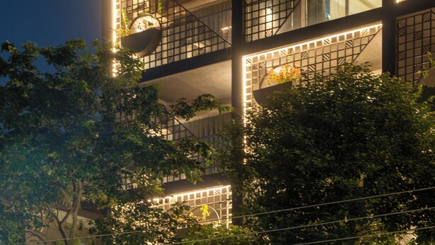 A multi-story building with balconies, large windows, and a rooftop garden. - The Aldott Hotel (Gurugram)