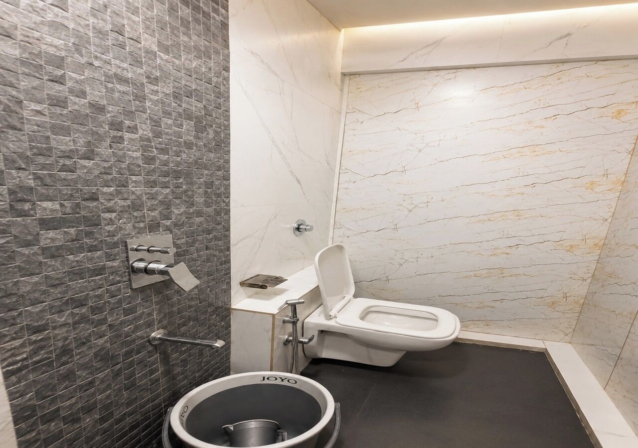 A modern bathroom with a toilet, a sink, and a bidet.