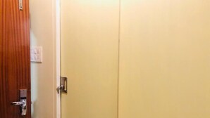 A closed wooden door with a metallic handle and a lock. - New Seven Hills By Glitz Hotels (Mumbai)