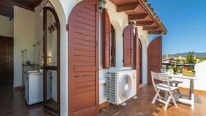 A patio with a table, chairs, and a fan. - Sant'Andrea by Interhome (Capitana)