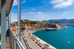 A coastal city with a historic fort, a marina, and a promenade.