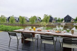 Dine al fresco with a view of the water and surrounding buildings.