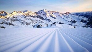 A snow-covered mountain landscape with a clear sky.