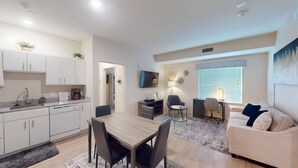 A modern apartment with a kitchen, dining area, and living space. - RD102 - Home|Yard|12mi to Convention Ctr|Sleeps 6 (Richardson)