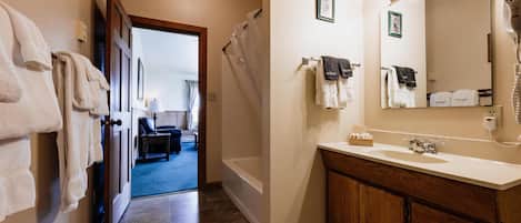 A bathroom with a sink, mirror, and towel rack.