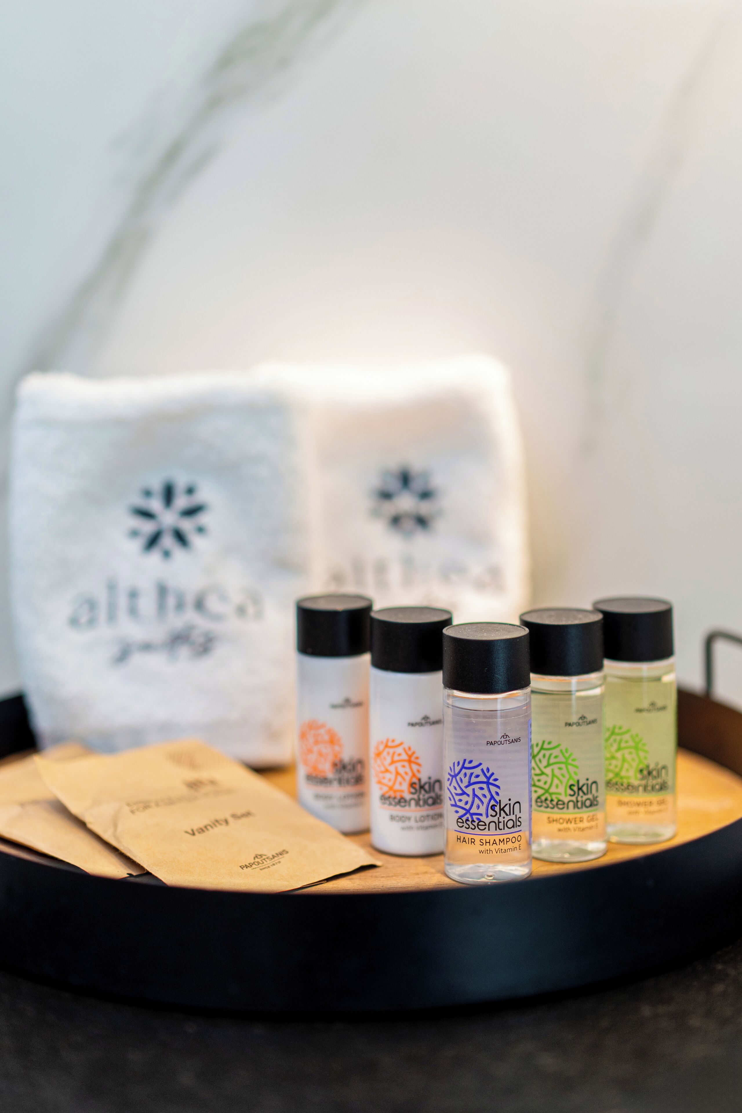 A tray with skincare products and a towel with a logo.