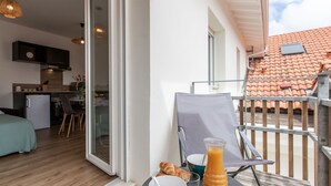 A balcony with a table set for breakfast, including croissants and a glass of orange juice. - Cap Océan by Interhome (Capbreton)