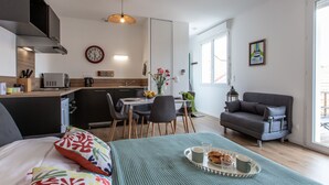 A modern apartment with a kitchenette, dining area, and a cozy living space. - Cap Océan by Interhome (Capbreton)