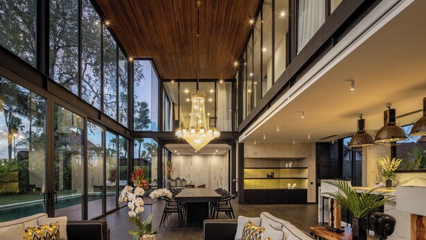 A modern interior with a dining area, seating, and a view of the outdoors. - Villa Gima 1 (Kerobokan)