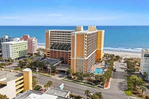 A hotel with multiple floors, a swimming pool, and a beach view. - New, Oceanview Suite - Caravelle 504 (Myrtle Beach)