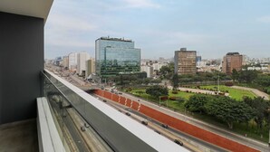 A cityscape with modern buildings, a highway, and a park. - w*| Fantastic 2BR w/ modern balcony in Miraflores (Lima)