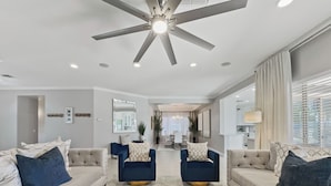 A modern living room with two sofas, a ceiling fan, and a dining area in the background. - 3 King Rooms, Sleeps 12 Heated Pool, Waterslide Paradise! 30 Night Min. (Queen Creek)