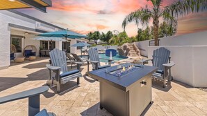 An outdoor patio with a pool, lounge chairs, and a foosball table. - 3 King Rooms, Sleeps 12 Heated Pool, Waterslide Paradise! 30 Night Min. (Queen Creek)