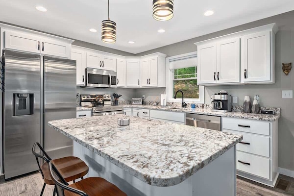 Kitchen is stocked with all of the essentials. Kitchen island provides seating for 2.