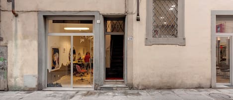 A building with a shop entrance, a visible number '10', and a window with a metal grille.
