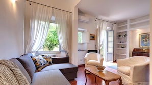 Una sala de estar con un sofá, un sillón y una mesa de centro de madera.