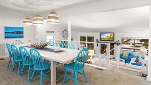 A modern living space with a dining area, a fireplace, and a television. - Anchors Away-Private Dock & Slip + Fire Pit + Kayak + Grill (Sunrise Beach)