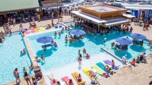 A large outdoor swimming pool with multiple lanes and lounge areas with umbrellas. - Anchors Away-Private Dock & Slip + Fire Pit + Kayak + Grill (Sunrise Beach)