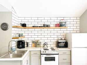 Fridge, microwave, oven, stovetop - Tackle Box 21 • Reel Cozy Cabin • Slip + Kayaks (Sunrise Beach)