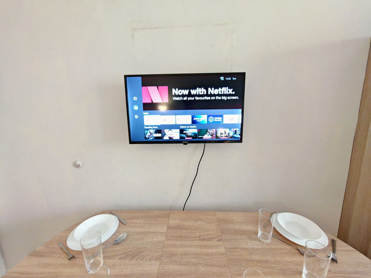 A television mounted on a wall displaying the Netflix interface.