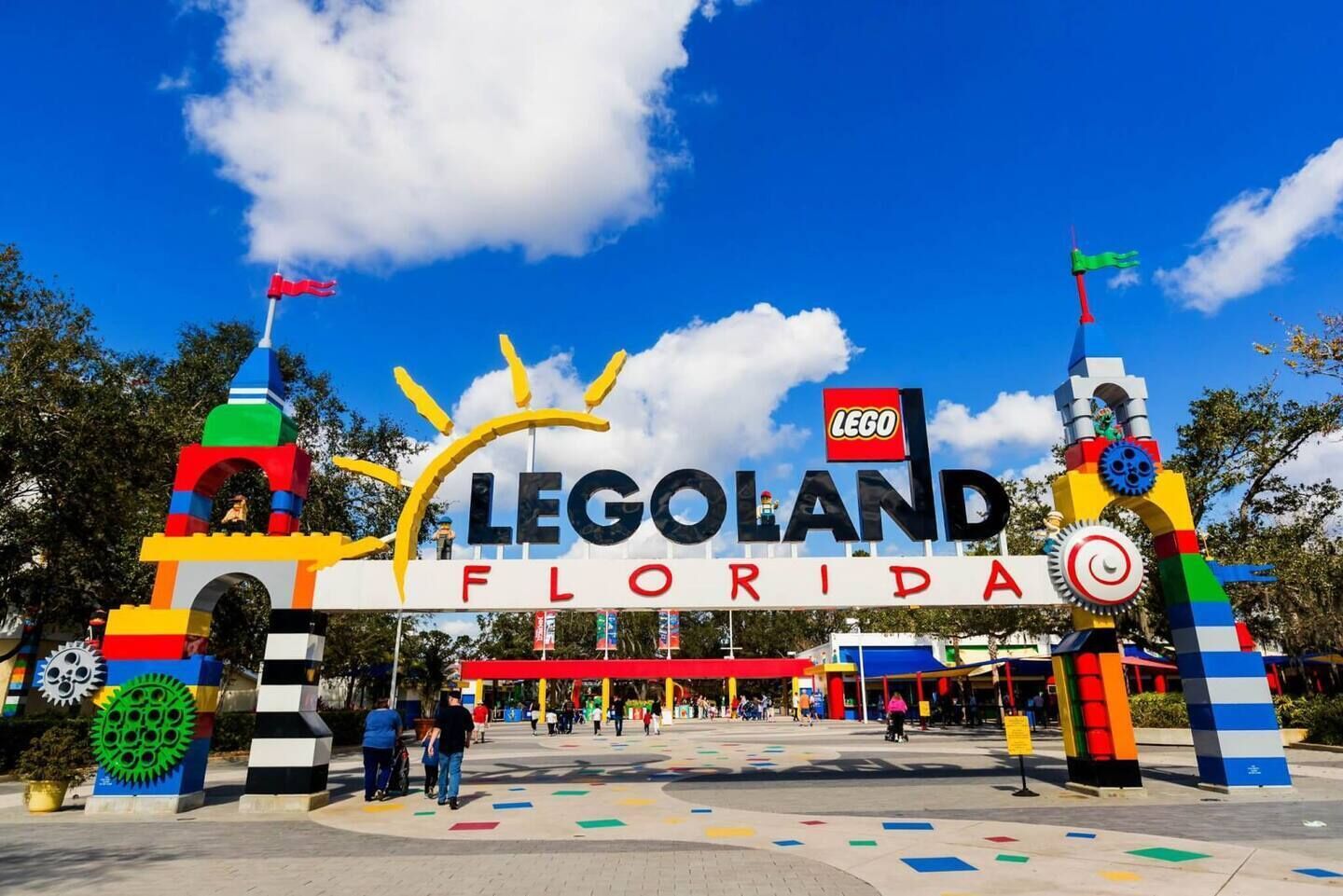 The entrance to LEGOLAND Florida with a colorful LEGO-themed archway and a clear blue sky.