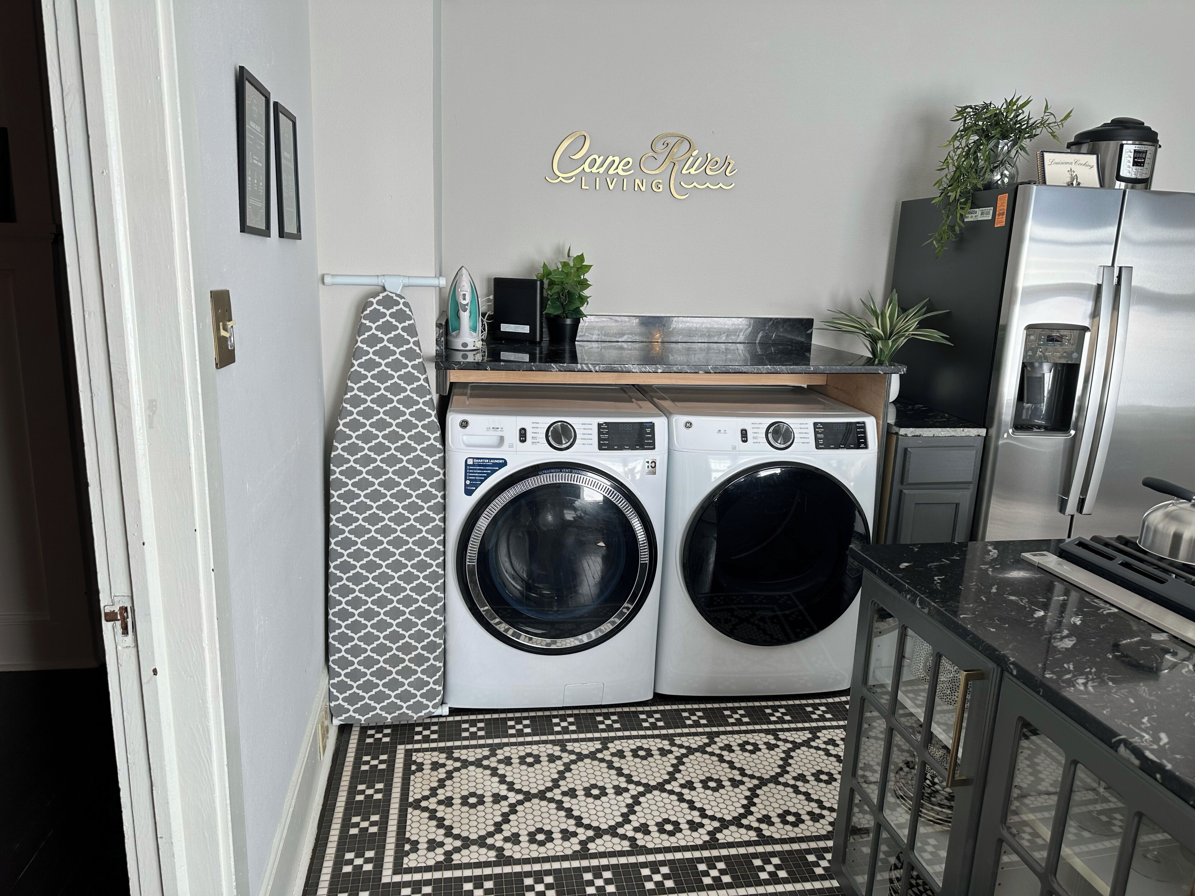 A compact laundry area with two front-loading washing machines, a coffee maker, and a water dispenser.