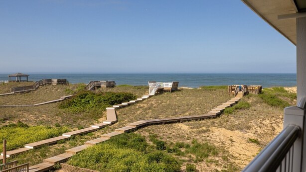 A beach view with wooden walkways and structures. - FFR201 My Happy Place by First Flight Rentals (Kill Devil Hills)