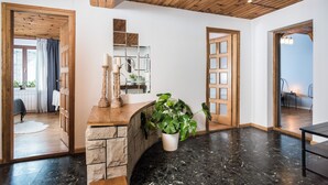 A spacious room with a stone fireplace, wooden ceiling, and a large potted plant. - ★ The Charm of the Center: Double Beauty ★ (Kraków)