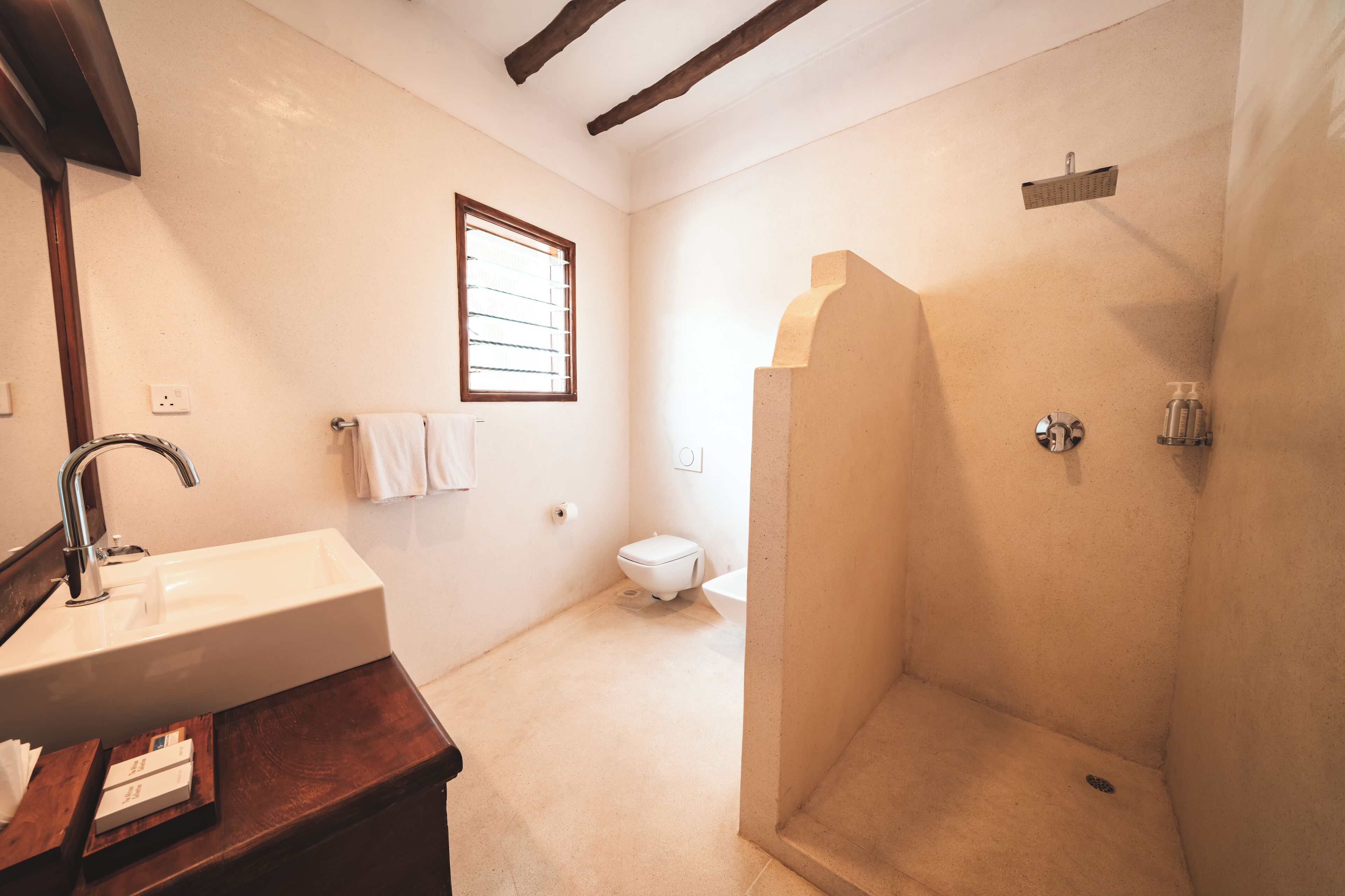 A bathroom with a sink, toilet, and shower.