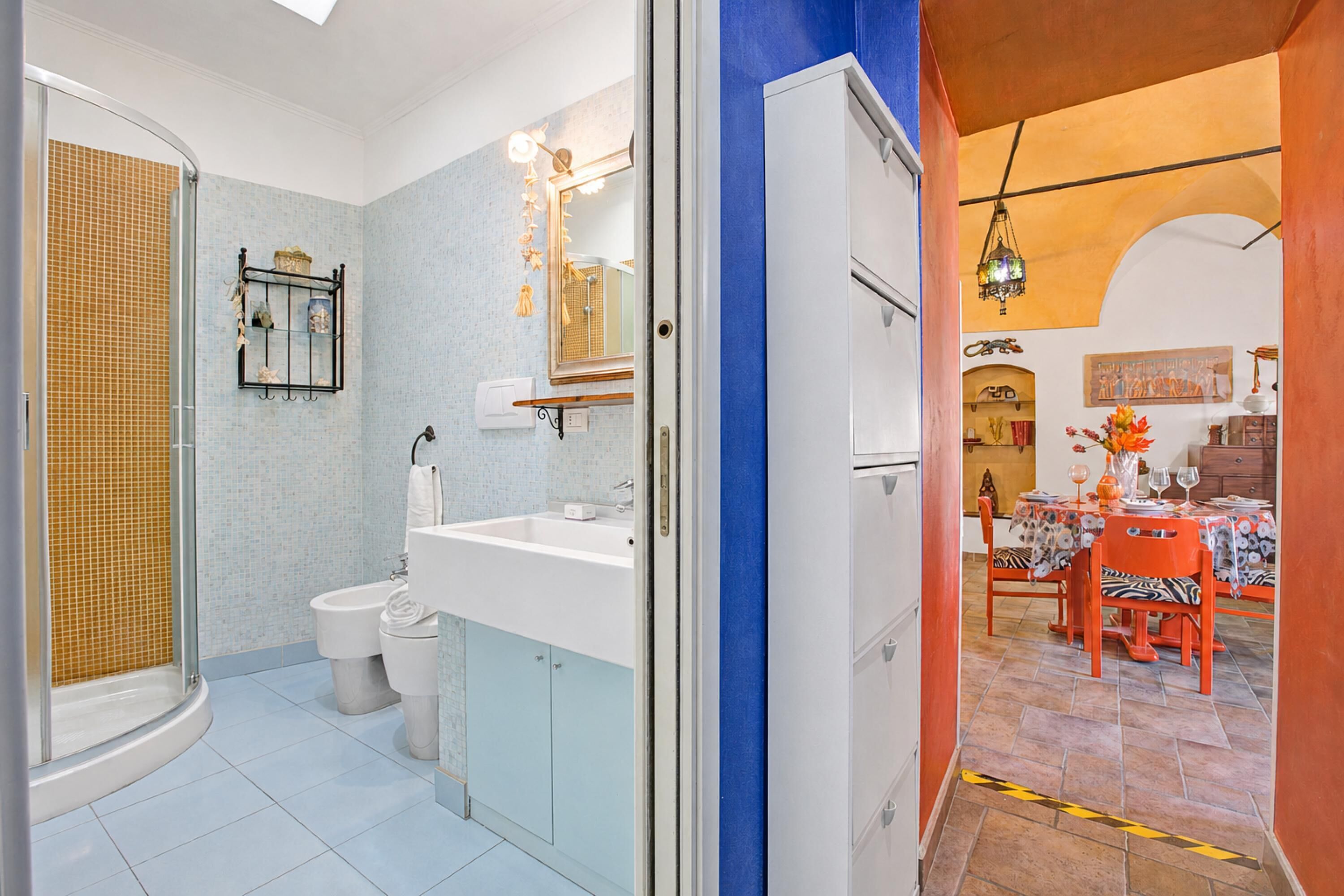 Une salle de bain équipée d’une douche, de toilettes, d’un lavabo et d’un miroir.