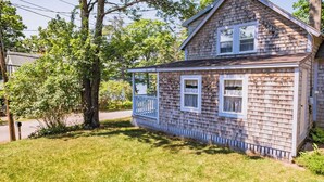 A two-story house with a porch, surrounded by trees and a well-maintained lawn. - Sweet Thing Summary: (Portland)