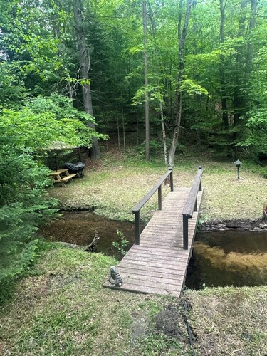 A Stream  runs through it. Comfy little cabin with a stream by your bedroom.