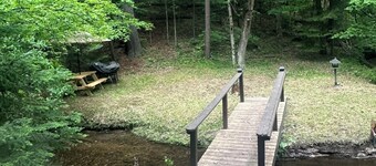 A Stream  runs through it. Comfy little cabin with a stream by your bedroom.