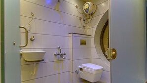 A modern bathroom with a toilet, sink, and shower.