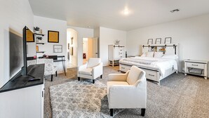 A modern bedroom with a large bed, a desk, a chair, and a wardrobe. - Year-round Yuma Escape Near Dtwn: Pets Welcome! (Yuma)