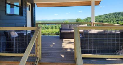 Small cottage house, centered on 100 acres surround by hills, lake, and cattle.