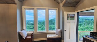 Small cottage house, centered on 100 acres surround by hills, lake, and cattle.