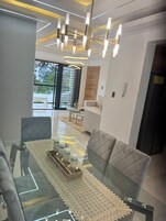 Comfort Apartment | Living area | 65-inch Smart TV with cable channels