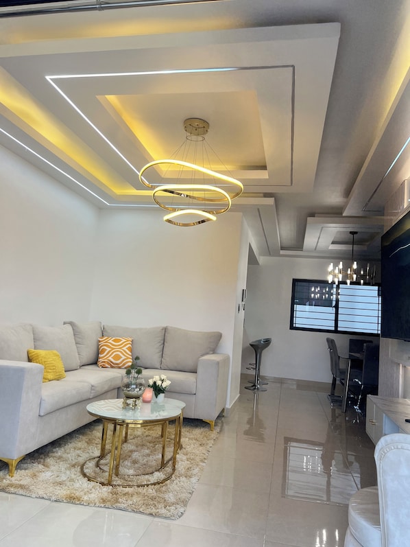 Comfort Apartment | Living area | 65-inch Smart TV with cable channels