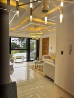 Comfort Apartment | Living area | 65-inch Smart TV with cable channels