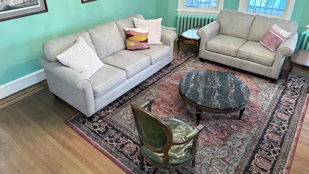 A living room with two sofas, a coffee table, and a patterned rug. - American Adventure AC family beach home (Atlantic City)
