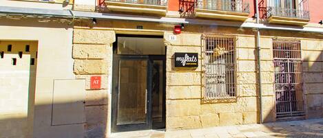 A building with a sign reading "myflats" and a visible entrance.
