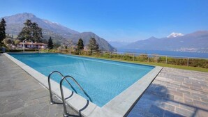 A swimming pool with a view of mountains and a lake. - FABULOUSLY LOCATED WITH VIEWS OF LAKE COMO WITH A HEATED POOL (Menaggio)