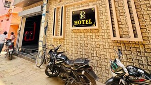A hotel with a stone facade and a signboard. - Hotel PSR Residency - near Temple & Ghat (Varanasi)