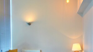 A modern living room with a sofa, armchair, and coffee table. - One Bed Penthouse Apartment in City Road (London)