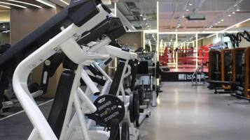 A gym with exercise equipment, including treadmills and weight machines.