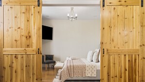 A bedroom with a bed, a desk, and a chair. - The Bell House - Contemporary Comfort Near Wards Road with a Luxurious Hot Tub! (Lynchburg)