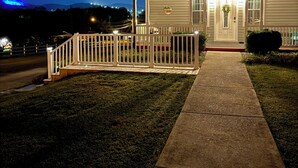 A two-story house with a white porch and a welcoming sign. - The Bell House - Contemporary Comfort Near Wards Road with a Luxurious Hot Tub! (Lynchburg)