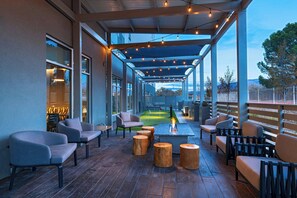 An outdoor patio area with seating, a fire pit, and a view of the surrounding landscape. - Fairfield By Marriott Inn & Suites Albuquerque Uptown (Albuquerque)
